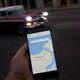 Man holds a phone with an app called Sube, Cuba’s homegrown version of Uber